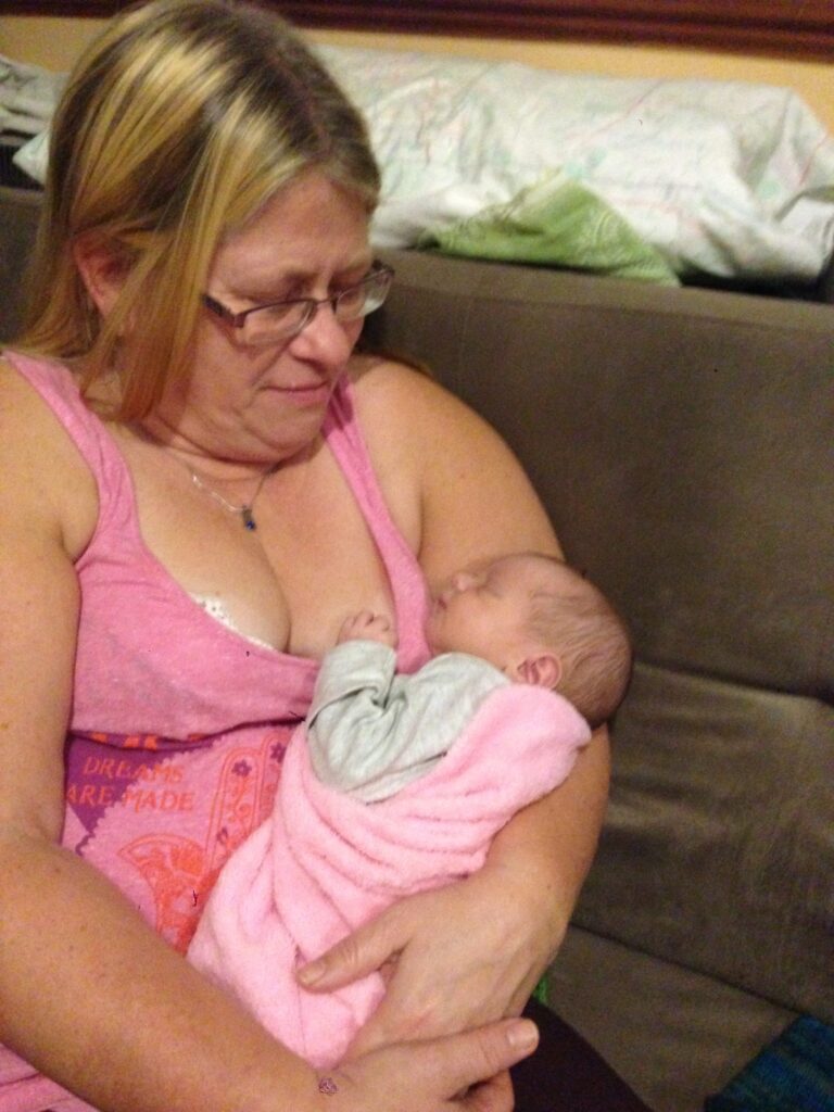 Susi holding a newborn baby.